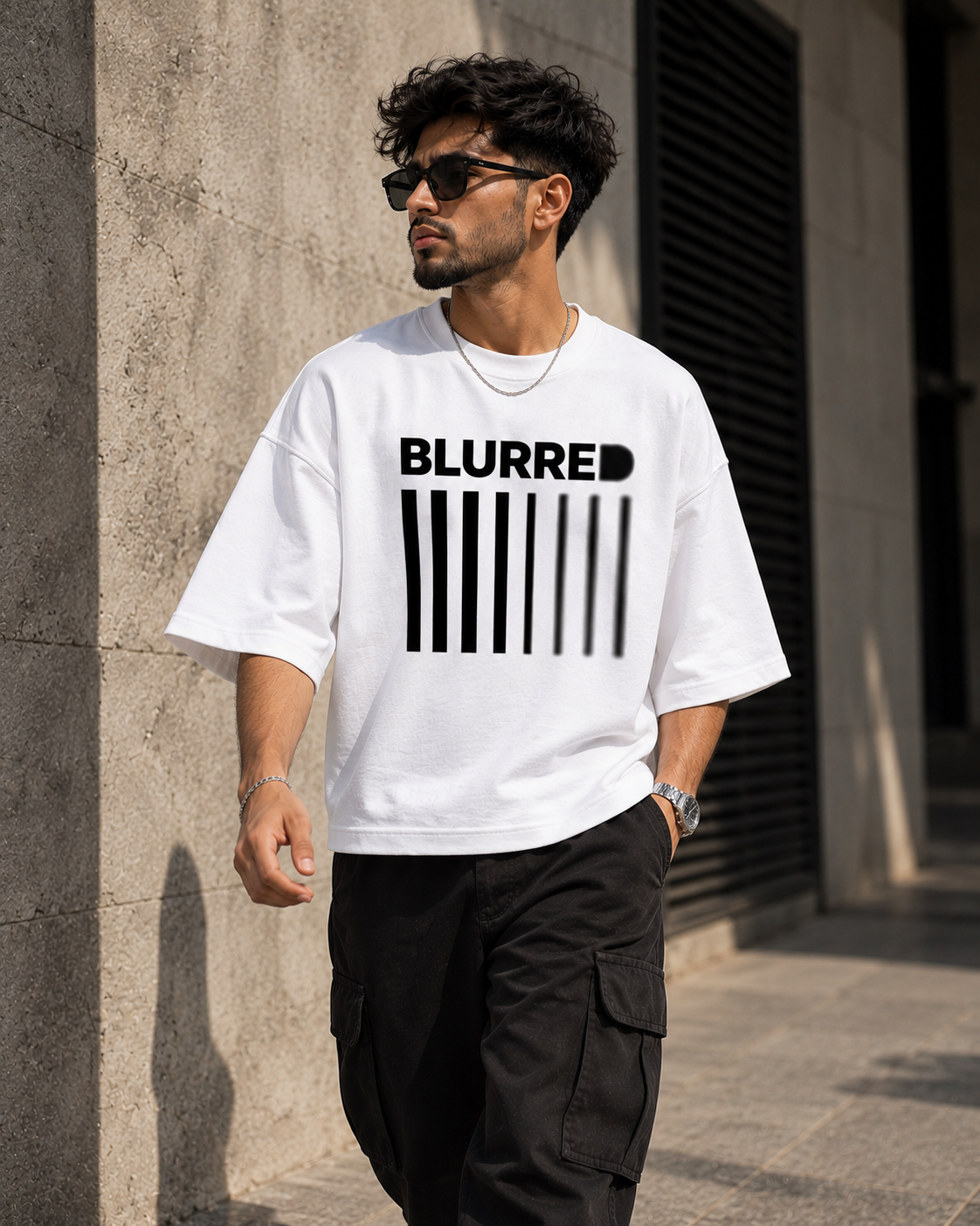 White Blurred oversized t-shirt lifestyle view featuring the bold barcode graphic and BLURRED typography