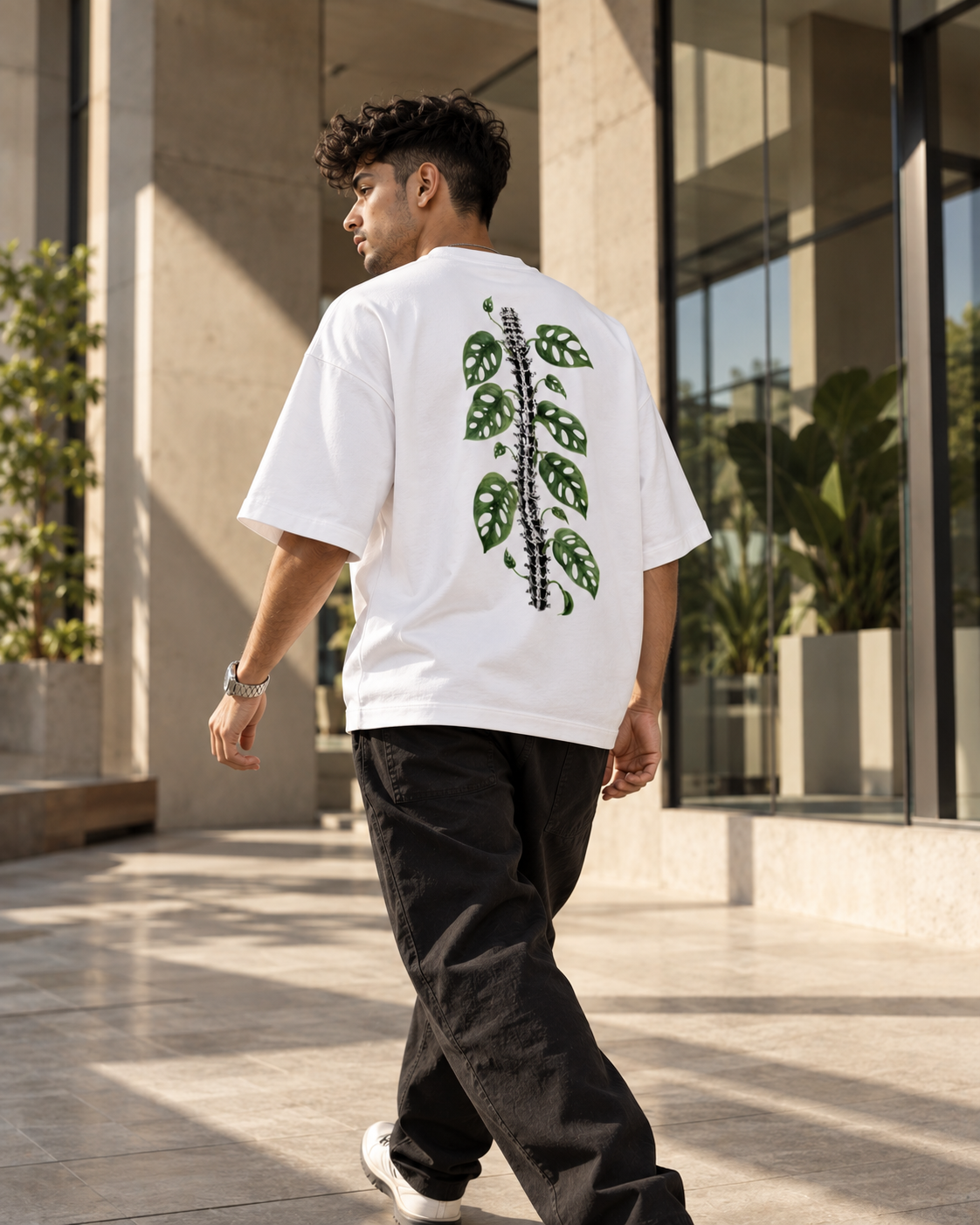 White Leaf Premium Oversized T-Shirt lifestyle view featuring green botanical leaf artwork